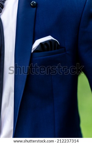 blue jacket of groom with yellow boutonniere