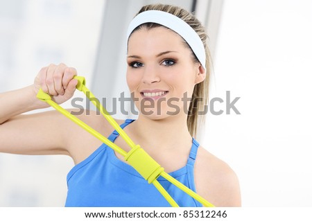 athletic woman doing gymnastic exercises with an elastic fitness