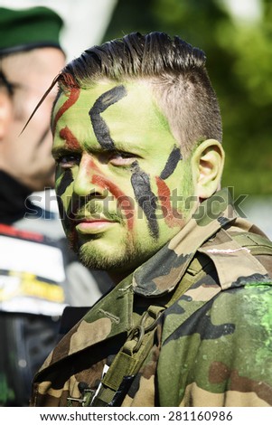 LYON, FRANCE - MAY 24: A man dressed in military commando looks on during the Frappadingue race event at the Miribel Jonage Park on May 25, 2015. People from all walks of life participate in the run.