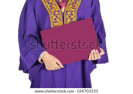 Young college graduate holding degree after convocation ceremony.