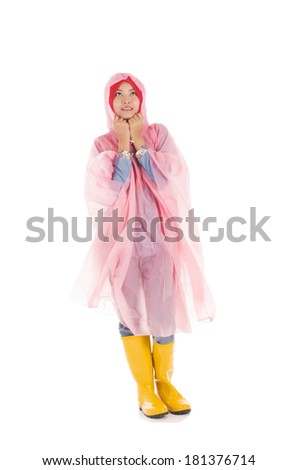Young muslimah wearing pink raincoat and yellow boot isolated on white