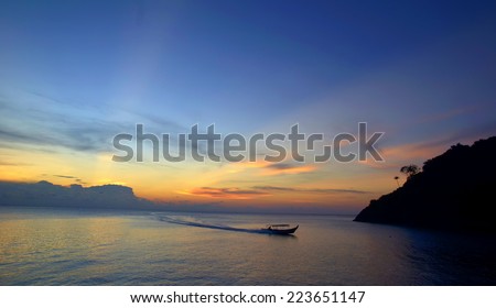 Sunrise Seascape with Fisherman Boat on the Sea (Soft focus, shallow DOF, slight motion blur)