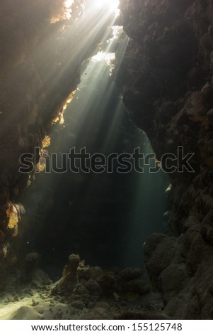 An amazing underwater view throw the cave-labyrinth, caverns in shallow water, Red Sea, Egypt