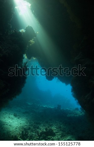 An amazing underwater view throw the cave-labyrinth, caverns in shallow water, Red Sea, Egypt