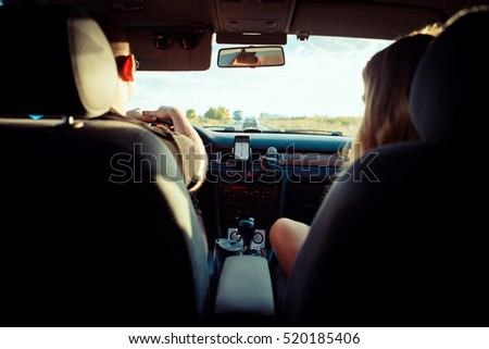 Young couple driving a car. Long journey