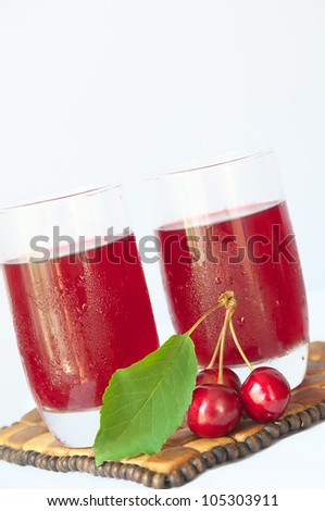 Two glasses of fresh cherry juice and fresh cherries