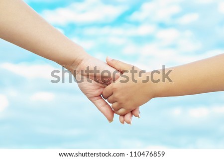 Young mother and her daughter holding hands