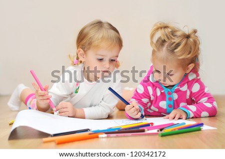 Two wonderful children draw with colored pencils Two wonderful children draw with colored pencils