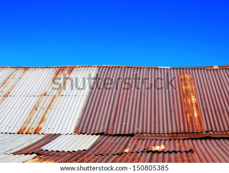 Old zinc roof with blue sky