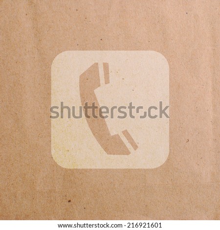 Phone symbol on brown paper sheet