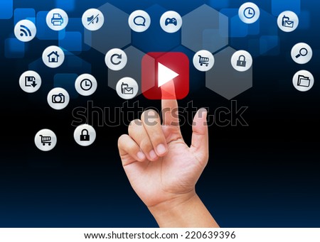 Hand pressing red play buttons on technology background