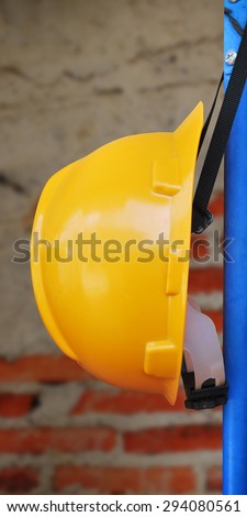 Safety helmet hanging brick wall background