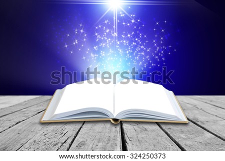 Opened magic book on abstract blue background