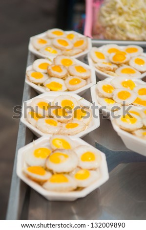 Fried quail egg on foam plate