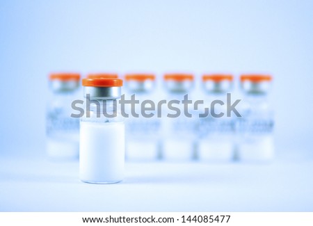 Orange cap injection vials show medicine background