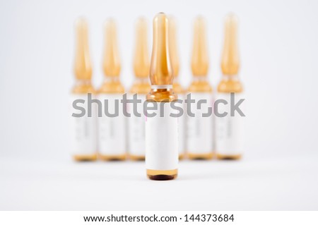 Closed up brown injection ampule show medicine background