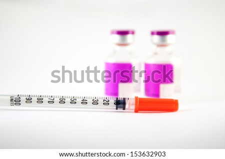 Disposable syringe and purple label injection vial show medicine background