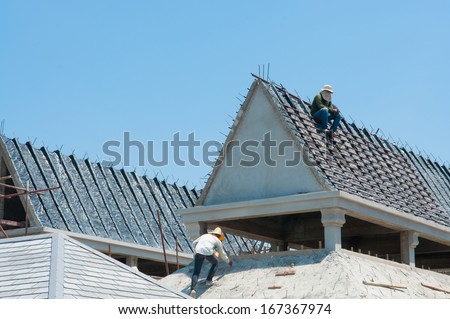 A construction worker on a high roof show risk concept