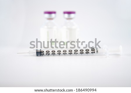 Disposable syringe and Purple cap of medicine injection vial