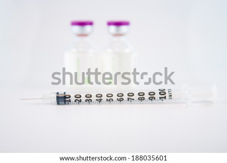 Disposable syringe and Purple cap of medicine injection vial
