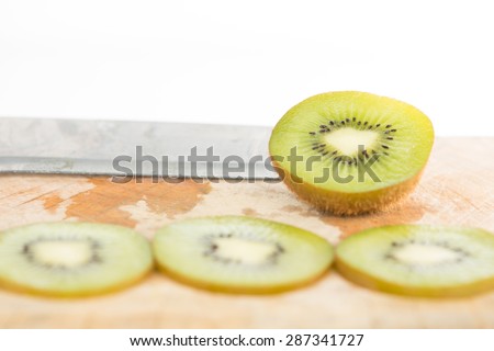 Closed up sliced kiwi fruit on wood floor