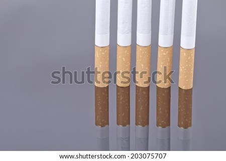 Cigarette on a reflective surface