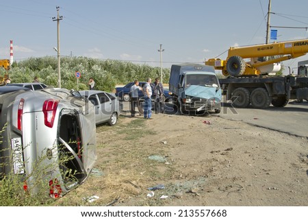 VOLGOGRAD - AUGUST 21: A traffic accident involving tractor Belarus, truck Gazelle and crossover Kia Sportage exceeding the speed limit. August 21, 2014 in Volgograd, Russia.