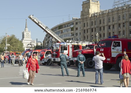 VOLGOGRAD - SEPTEMBER 6: Fire engines at the exhibition stand under the open sky on the background of the Central train station. . September 6, 2014 in Volgograd, Russia.
