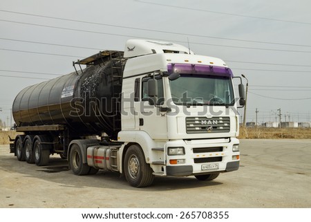 VOLGOGRAD - MARCH 27: A truck with a tank for the transport of petroleum products is on the paved lot in the industrial zone. March 27, 2015 in Volgograd, Russia.
