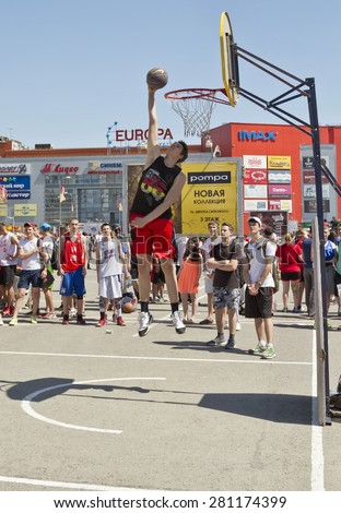 VOLGOGRAD, RUSSIA - MAY 24: A young basketball player performs a throw to the slam dunk contest during the annual streetball party organized by Europa city Mall, on May 24, 2015 in Volgograd, Russia.