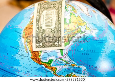 Bill one dollar covers North America on a globe