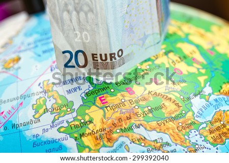 Twenty Euro banknote is worth on the globe next to Europe