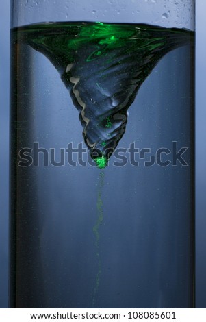 whirlpool with green mist - vortex in a column of water