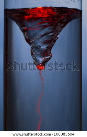 whirlpool with red mist - vortex in a column of water