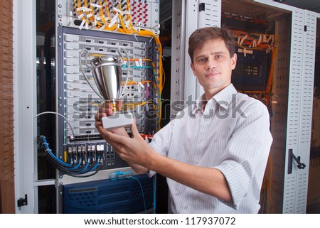 Network engineer in server room with the cup
