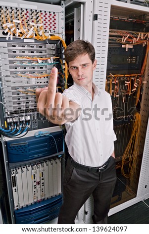 Network engineer in server room show finger