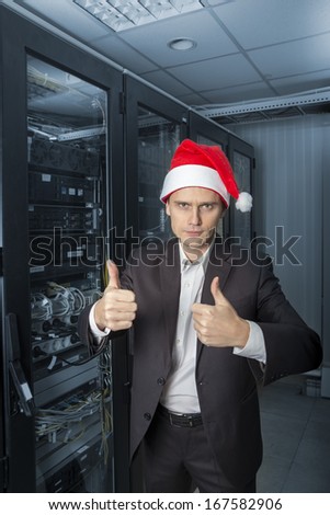 Network Engineer  in the server in Santa Claus hat show OK on colorize background