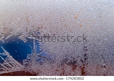 Macro Ice flowers. Frost flowers. Window frost. Winter in the window. Color gradient