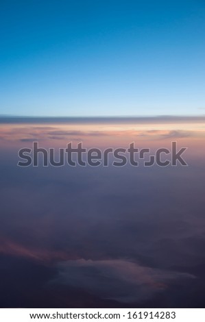 Endless sky with different colors and shades of blue, orange, red, pink, gray, clouds of different shapes during sunset. Copy space