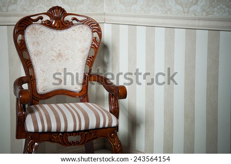 Retro wooden chair in empty room against light beige wallpapers. Copy space