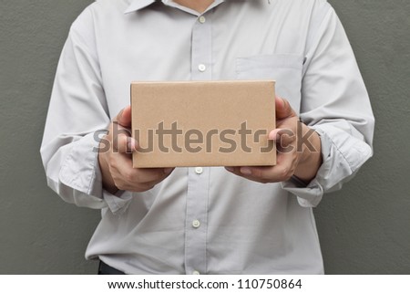 Man in white shirt carry recycle paper box hand under