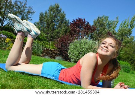 fitness, sport, training, woman doing exercises on mat outdoors  and smiling. lifestyle fitness concept
