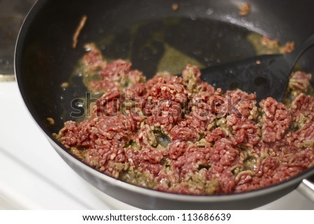 Restaurant cooking mince meat in frying pan