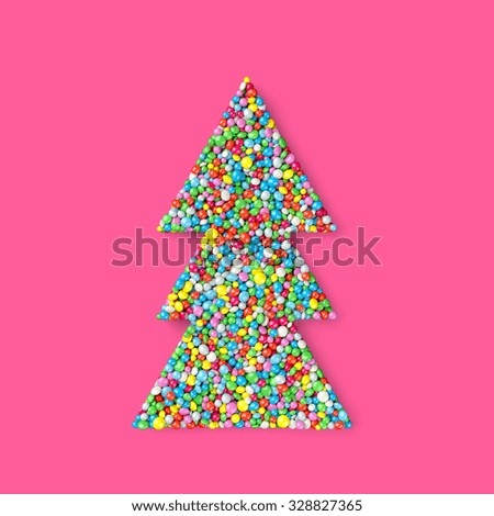 Christmas tree coated with nonpareils of different colors isolated on pink background