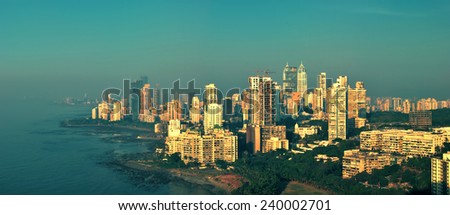 Panoramic view of Mumbai\'s afluent Napean Sea area with Arabian sea at sunset in a warm glow. Here most of super rich billionaires and millionaires stay in high-rise towers. Copy space.