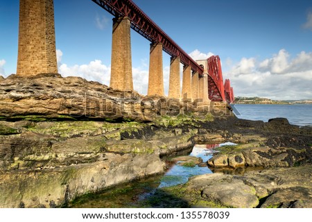 The Forth Bridge is a cantilever railway bridge over the Firth of Forth in the east of Scotland, to the east of the Forth Road Bridge, and 14 kilometres (9 mi) west of central Edinburgh.