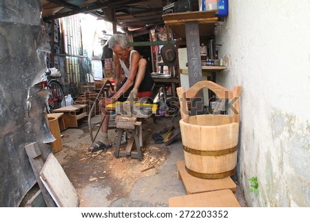 MELAKA, MALAYSIA - OCTOBER 21, 2013 : An old fashioned carpenter in Melaka, Malaysia.