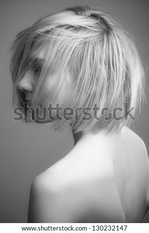 A beautiful young woman with short hair back