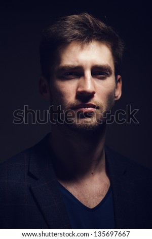 Portrait of a handsome young man on a dark background