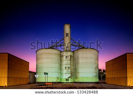 Old grain storage rustic silo during a stunning pink purple blue dusk sunset in country Victoria of Australia